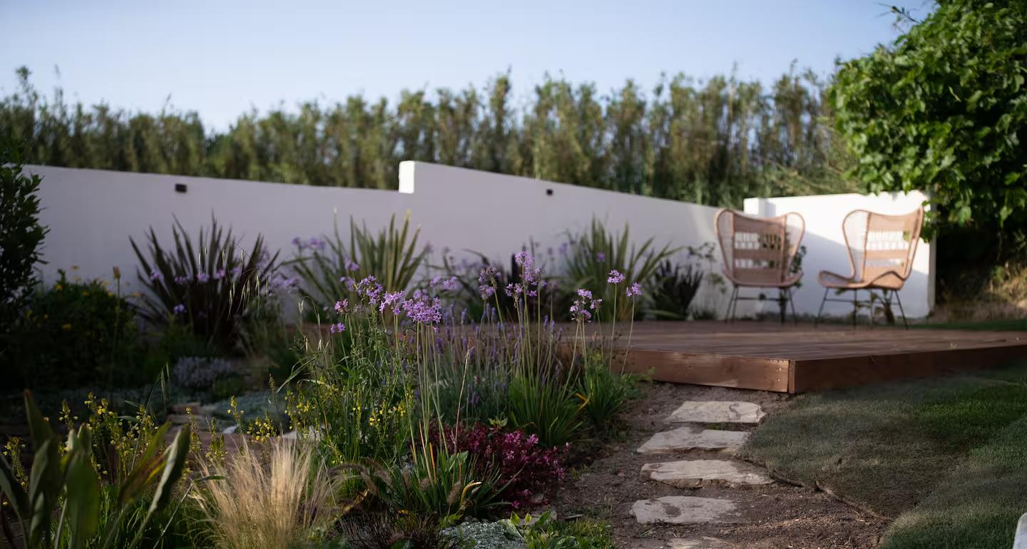 Planted garden with stone path and deck